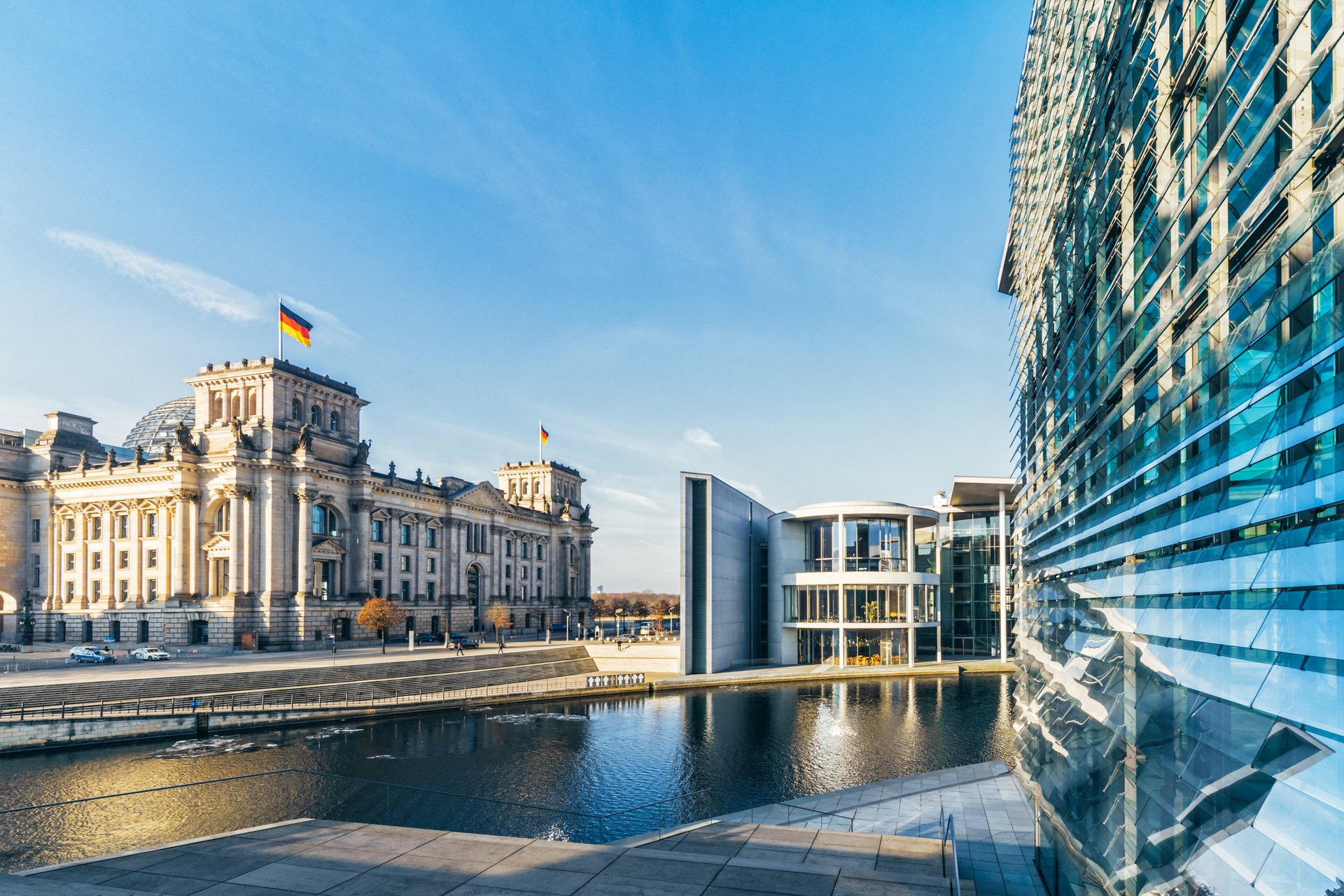 Fernansicht des Bundestags und weiterer Gebäude mit blauem Himmel und der Spree