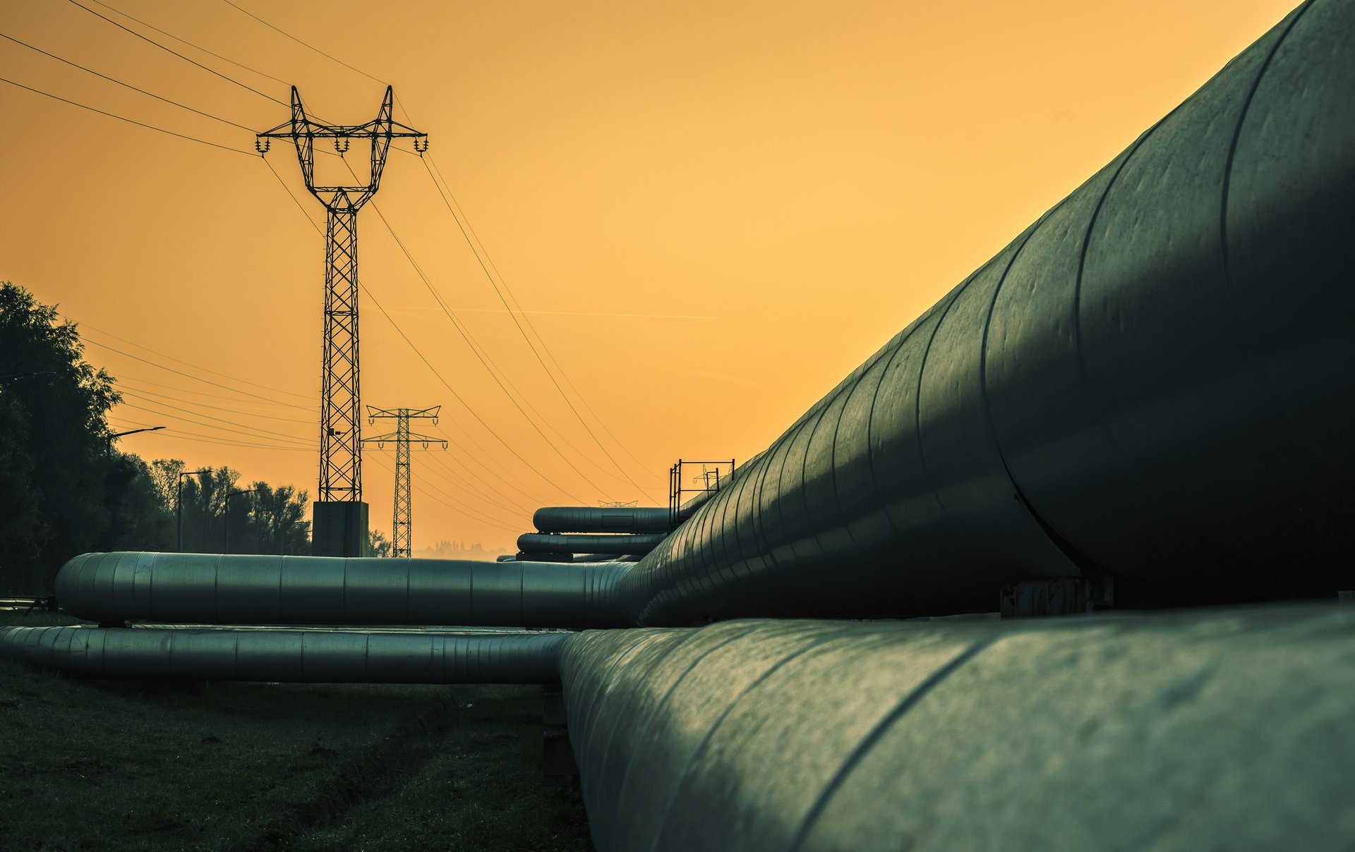 Elektrische Drähte und Fernwärmerohre bei Sonnenaufgang