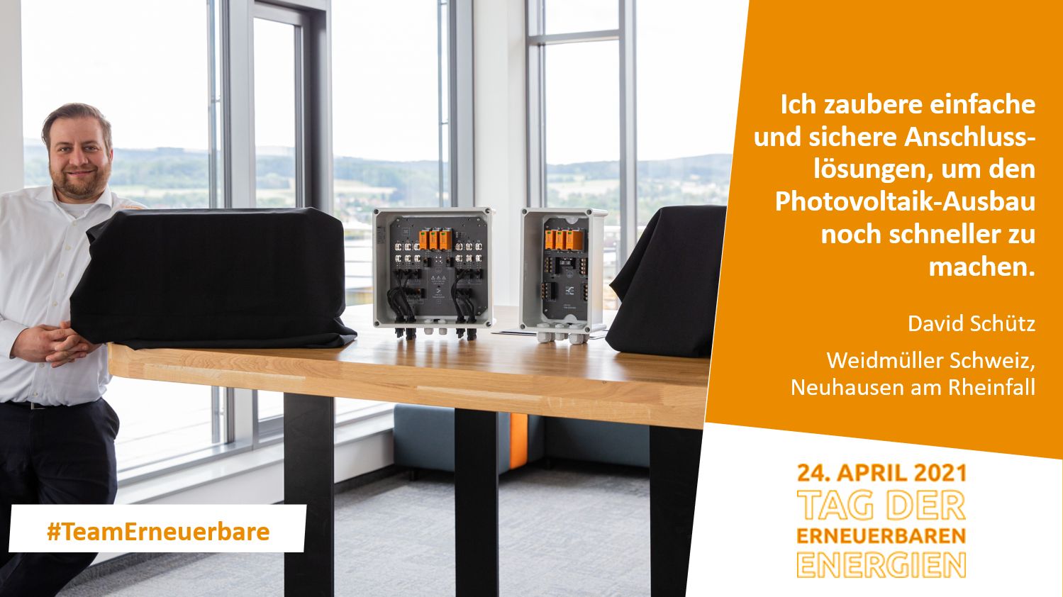 Mann steht an einem Tisch mit elektronischen Geräten für den PV-Ausbau