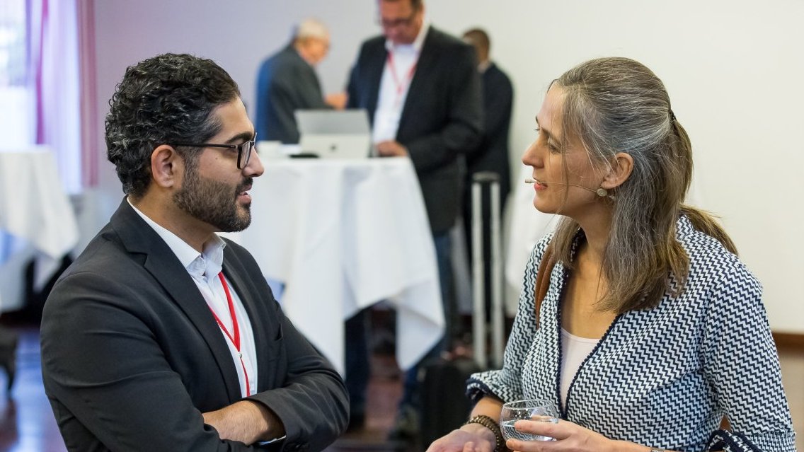 Ahmad Sandid unterhält sich mit Frau bei Veranstaltung