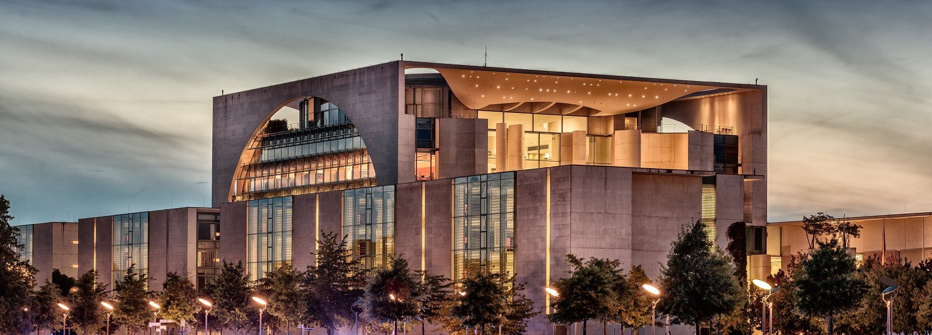 Beschreibung: Außenansicht des Bundeskanzleramts beleuchtet vor dunklem Himmel