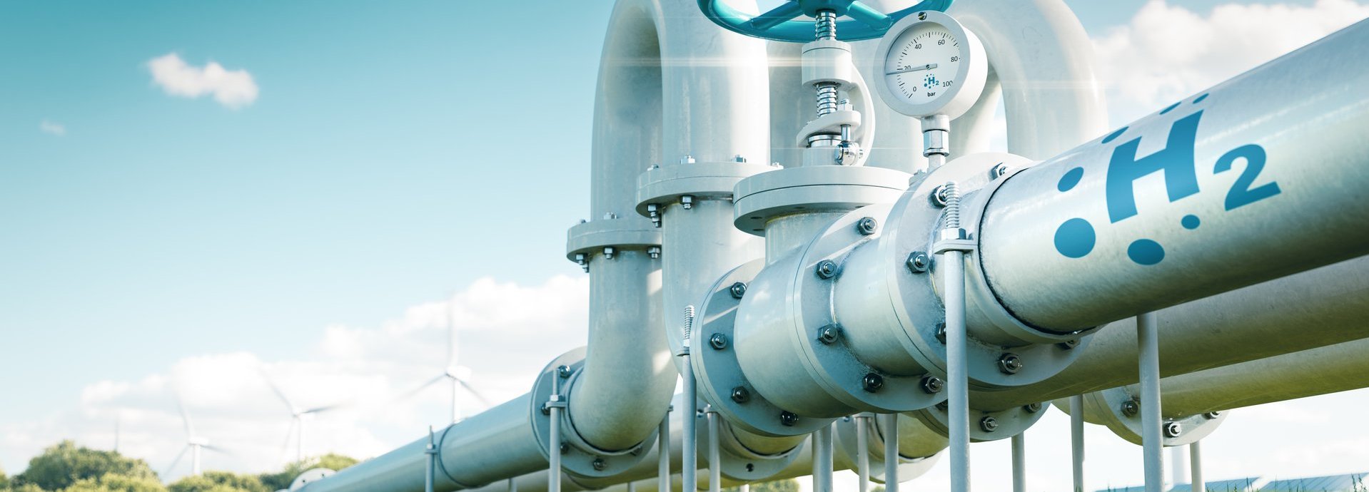 Beschreibung: Rohr mit Wasserstoff auf einer grünen Wiese und vor blauem Himmel
