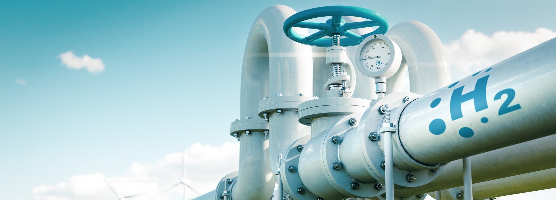 Beschreibung: Rohr mit Wasserstoff auf einer grünen Wiese und vor blauem Himmel