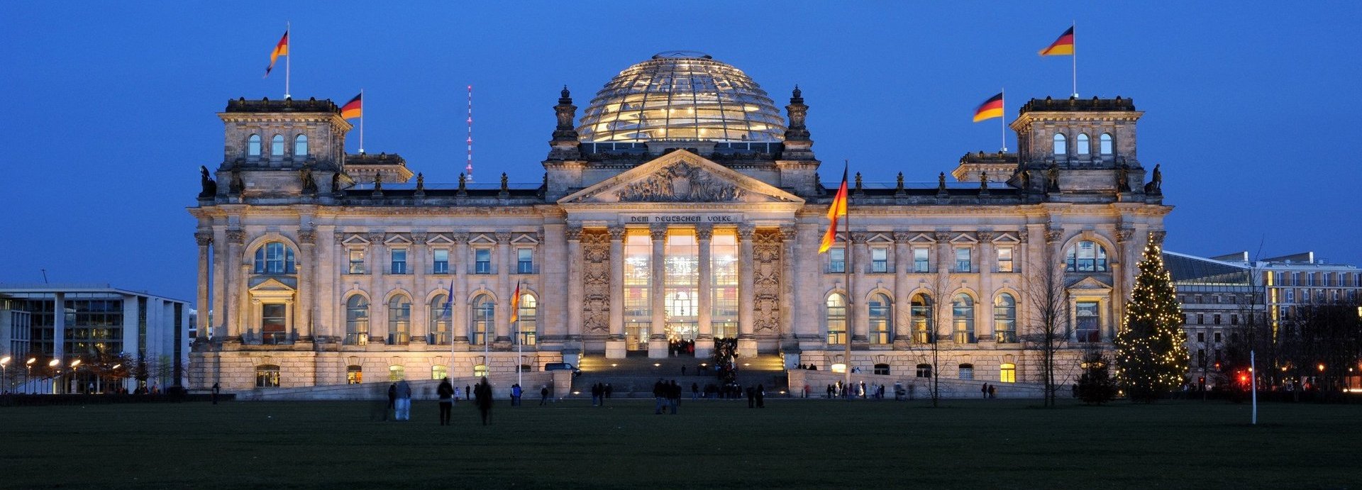 Angeleuchtetes Bundestagsgebäude vor dunkelblauem Himmel