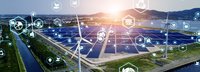 Icons aus dem Energiebereich vor einem Solargrid und Windrädern