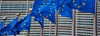Gebäude der Europäischen Kommission. Im Vordergrund wehende EU Flaggen