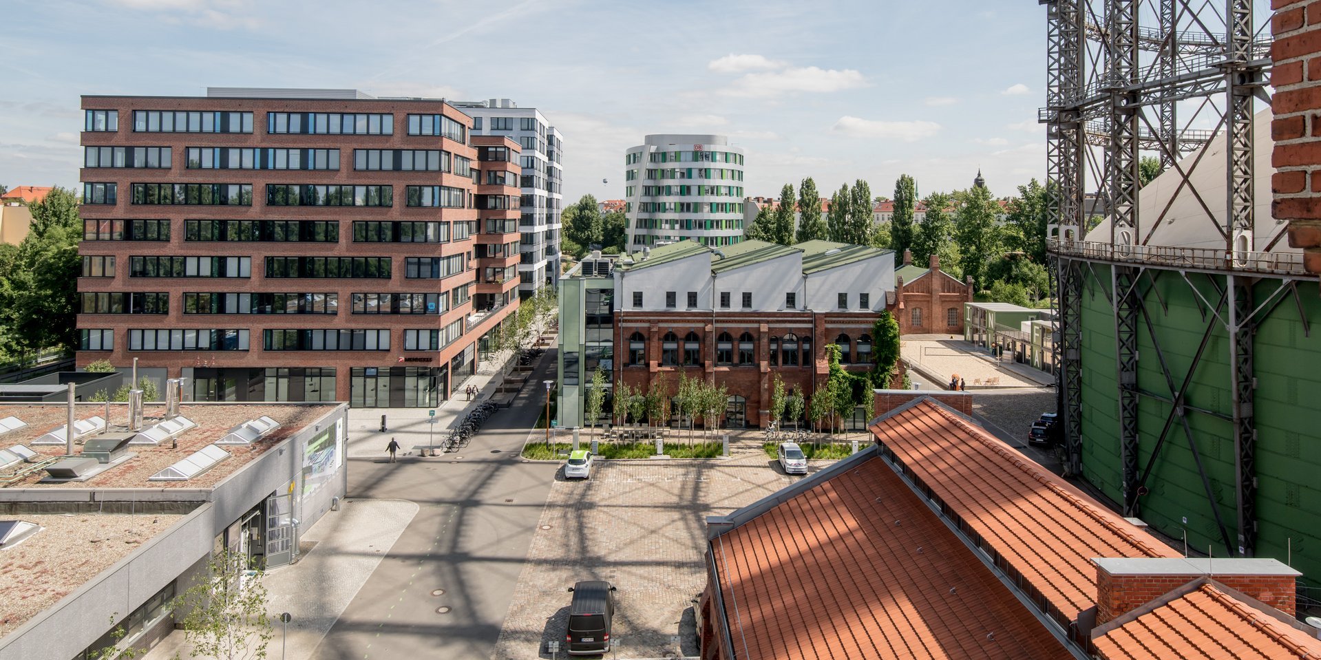 Erhöhte Ansicht auf den EUREF Campus mit vereinzelten Menschen und geparkten Autos